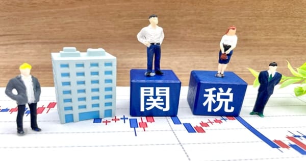 関税と書かれたブロックとビジネスマンのミニチュア